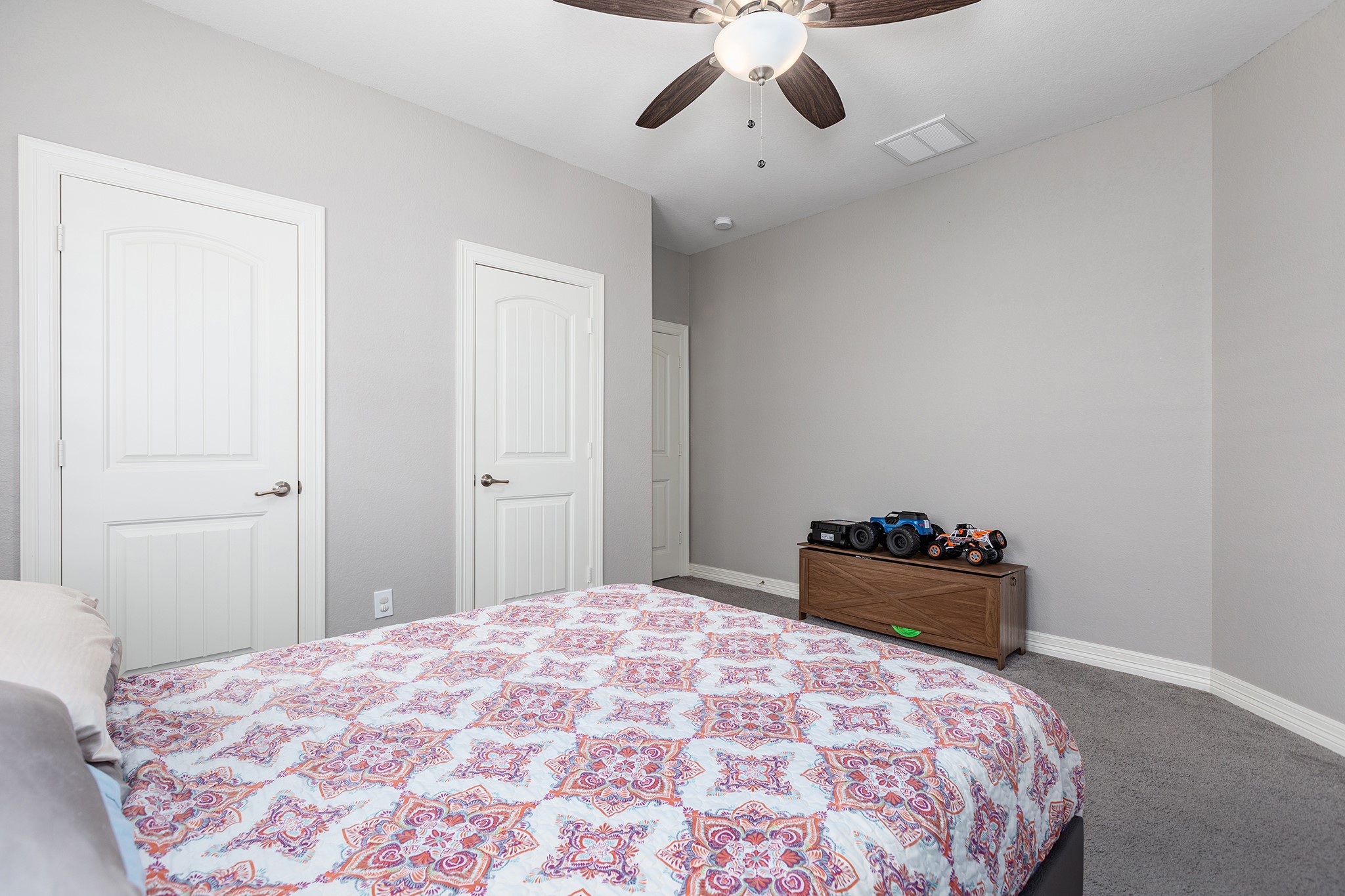 27600 Rio Blanco Drive Splendora, TX 77372 - Photo 29 of 49 a bedroom with a bed and a chandelier