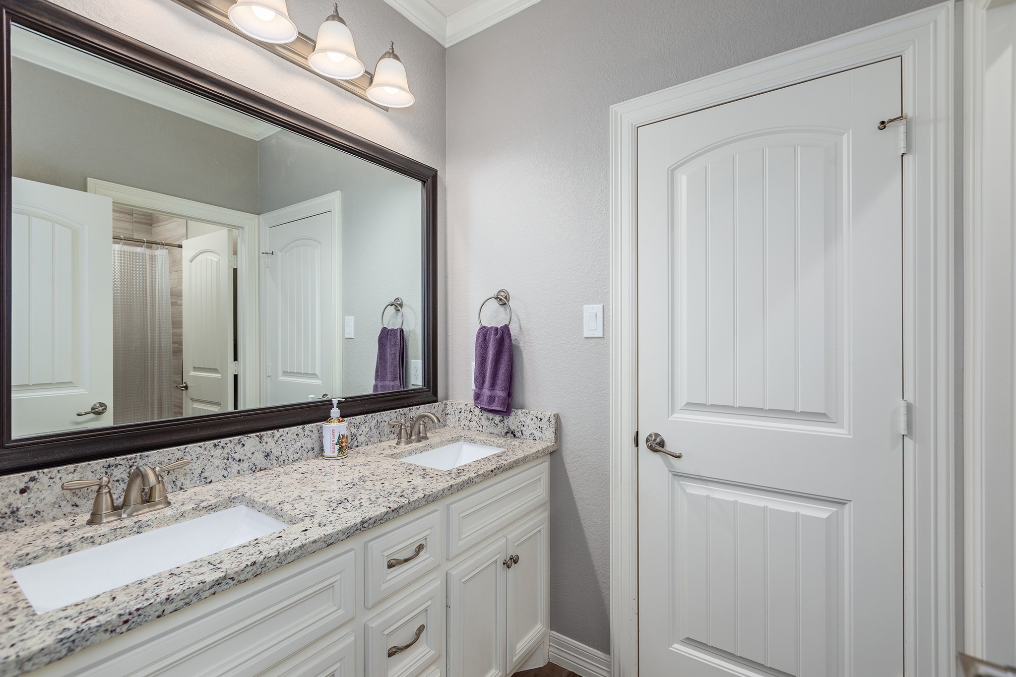 27600 Rio Blanco Drive Splendora, TX 77372 - Photo 30 of 49 a bathroom with a granite countertop double vanity sink and a mirror