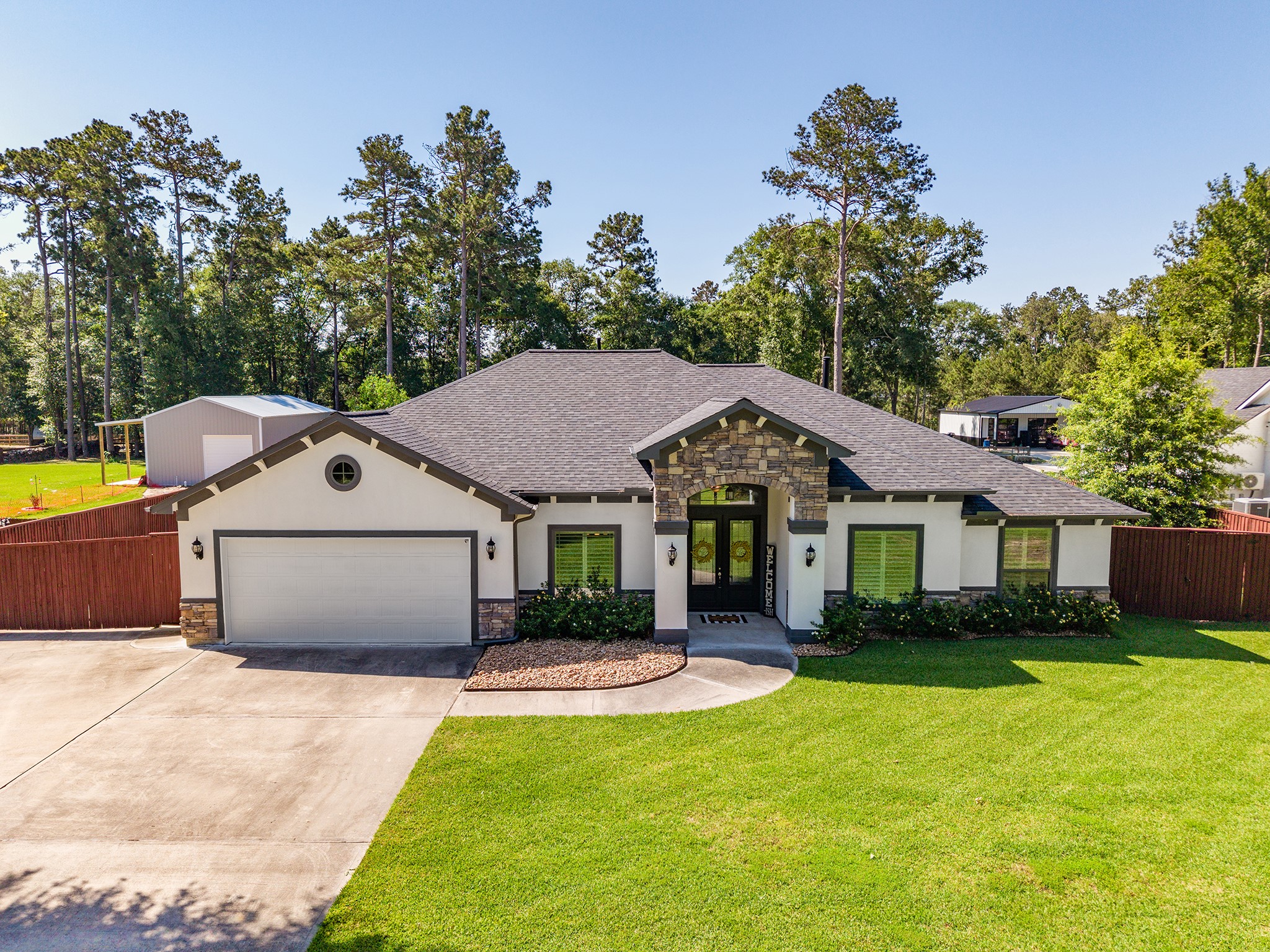 27600 Rio Blanco Drive Splendora, TX 77372 - Photo 49 of 49 a front view of a house with a yard and trees