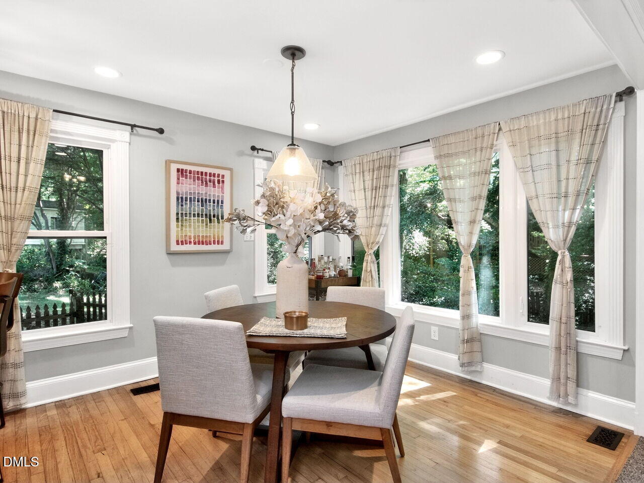 6004 Tarnhour Court Raleigh, NC 27612 - Photo 9 of 44 a dining room with furniture a chandelier and wooden floor