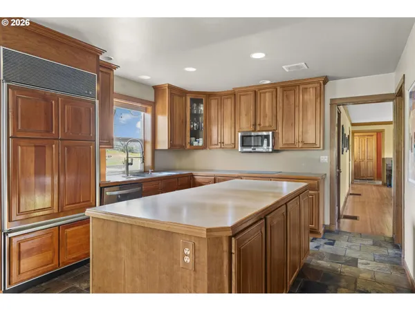 a kitchen with a refrigerator a sink and cabinets
