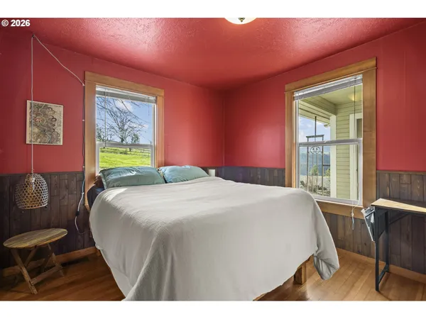 a bedroom with a bed a table and chair