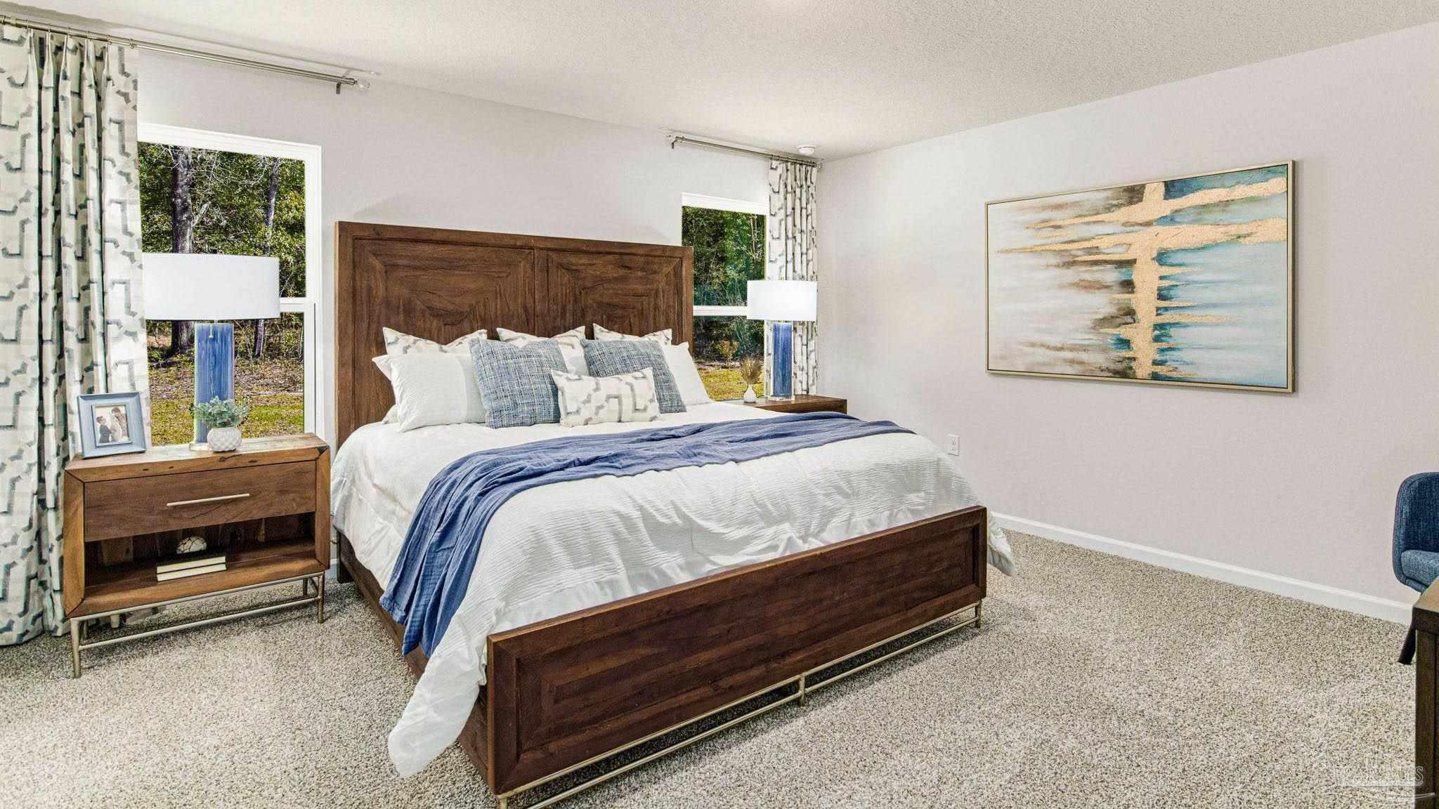 9732 Dutton Lane Milton, FL 32583 - Photo 11 of 24 a bed sitting in a bedroom next to a window