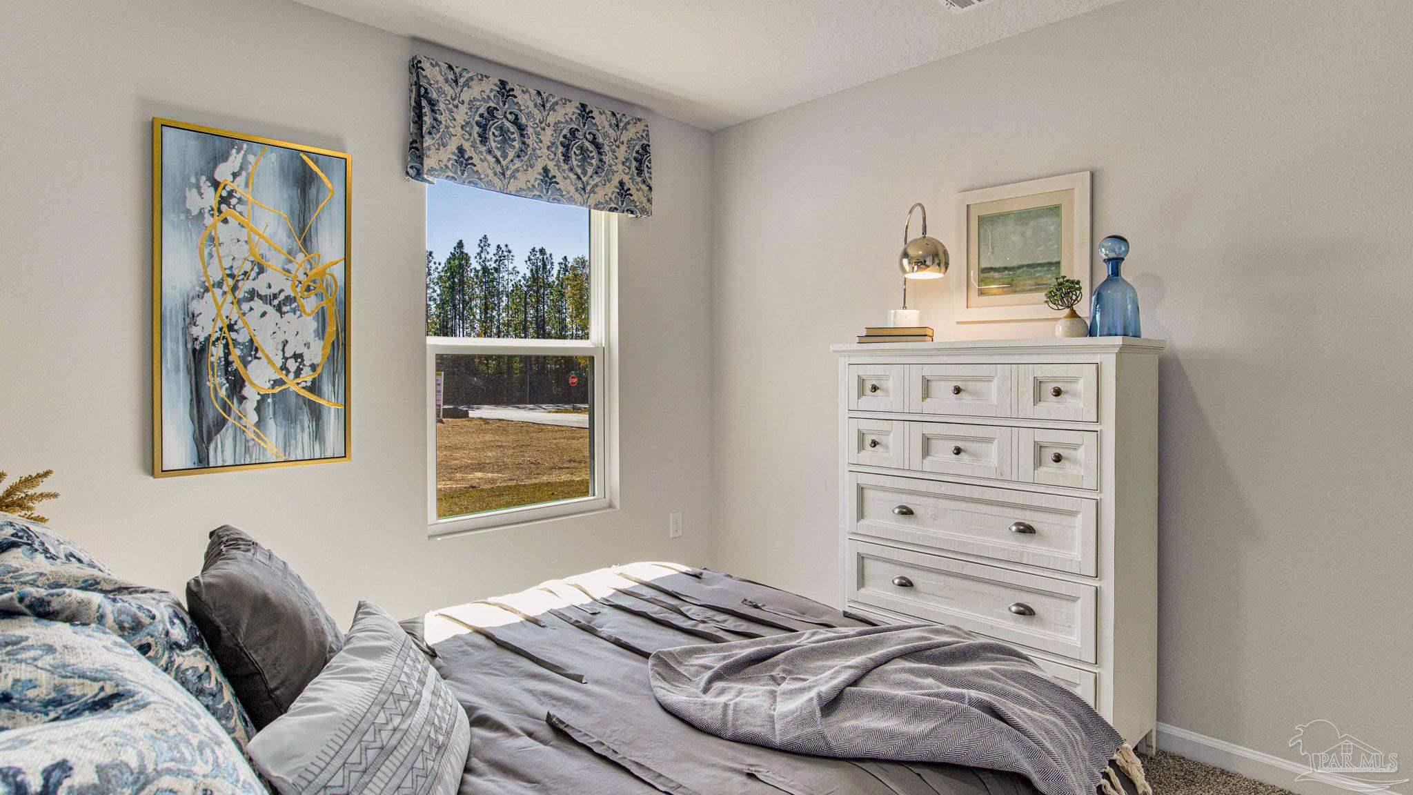 9732 Dutton Lane Milton, FL 32583 - Photo 18 of 24 a bedroom with a bed and a window