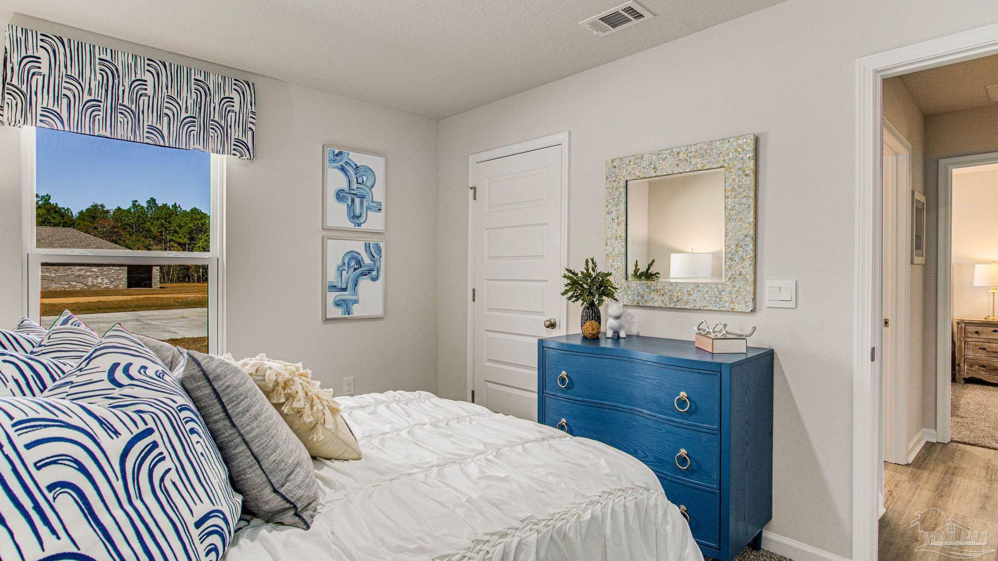 9732 Dutton Lane Milton, FL 32583 - Photo 19 of 24 a bedroom with a bed and a potted plant