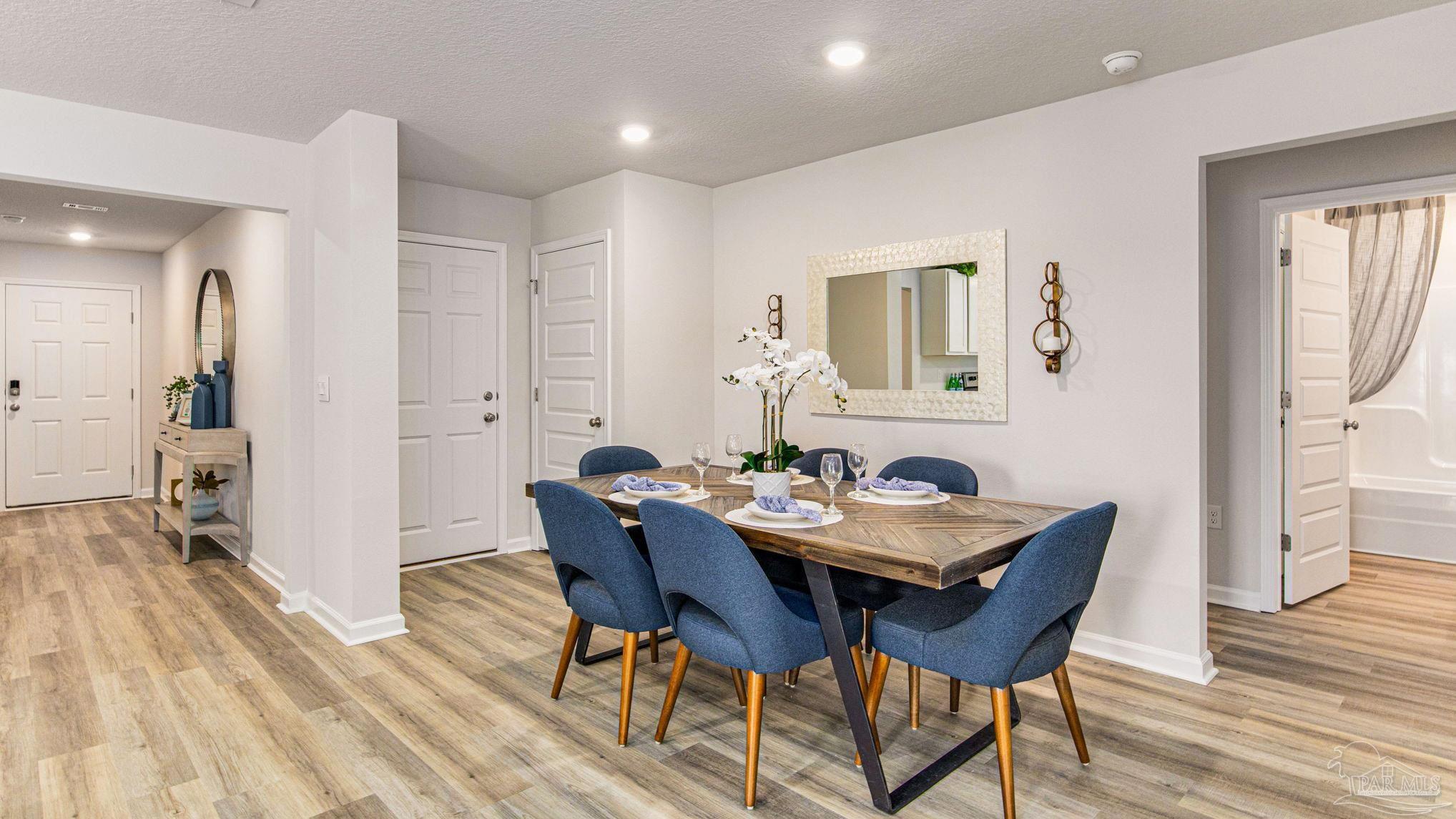 9732 Dutton Lane Milton, FL 32583 - Photo 3 of 24 a view of a dining room with furniture and wooden floor