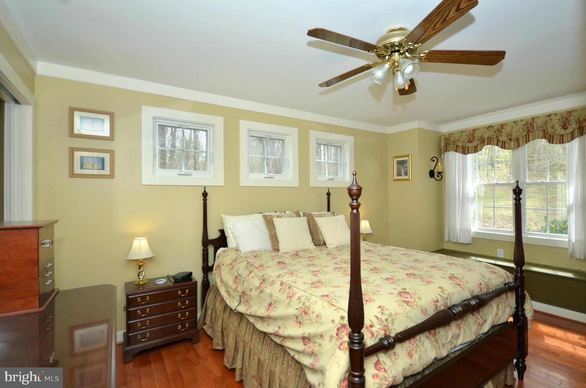 14045 Sunnybrook Road Phoenix, MD 21131 - Photo 13 of 27 a bed sitting in a bedroom next to a window