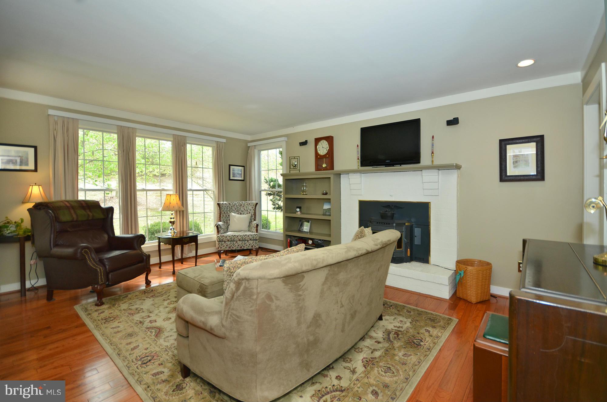 14045 Sunnybrook Road Phoenix, MD 21131 - Photo 3 of 27 a living room with fireplace furniture and a flat screen tv