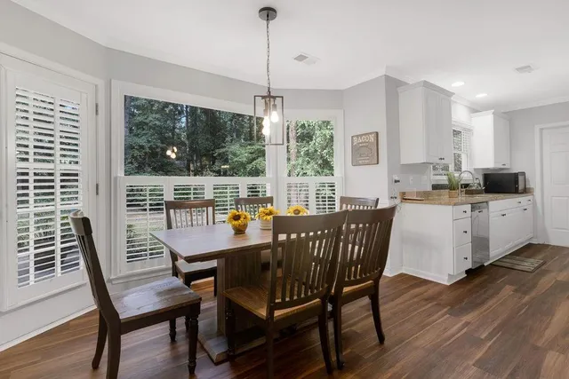 a view of a dining room with furniture window and wooden floor