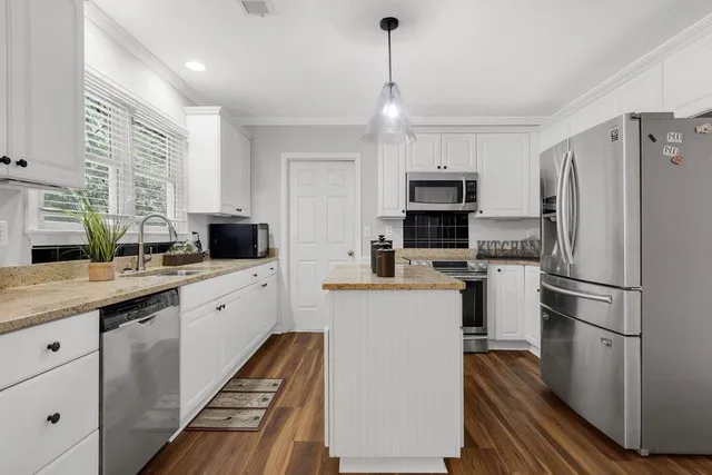 a kitchen with sink cabinets and stainless steel appliances