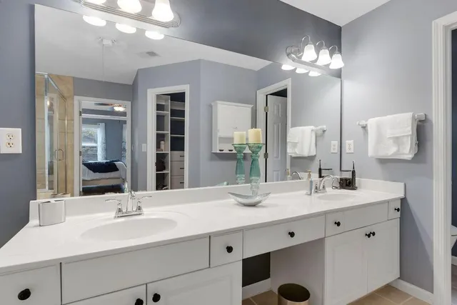 a bathroom with a sink double vanity and a mirror