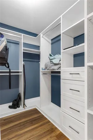a view of walk in closet with empty racks