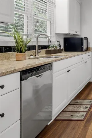 a kitchen with granite countertop a sink and a stove