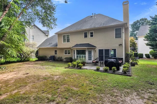 a front view of a house with yard and patio