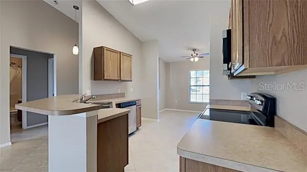 a kitchen with granite countertop a sink stove and refrigerator