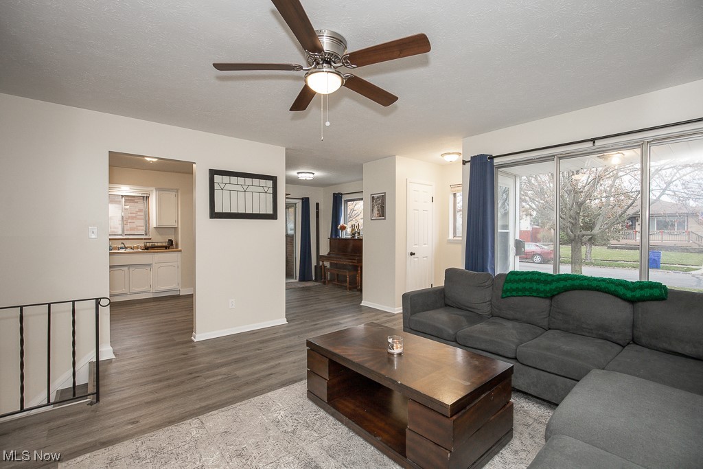 4357 Valleyside Road Cleveland, OH 44135 - Photo 5 of 26 Living room with ceiling fan, light hardwood / wood-style floors, and a textured ceiling