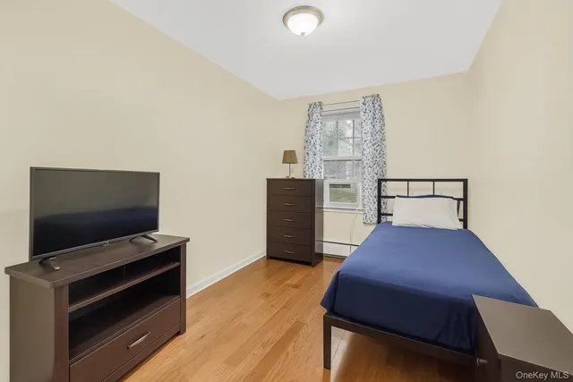 a bedroom with a bed and flat screen tv