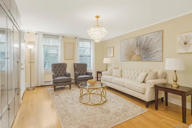 a living room with furniture and a chandelier
