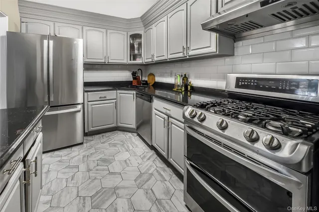 a kitchen with stainless steel appliances granite countertop a stove and a refrigerator