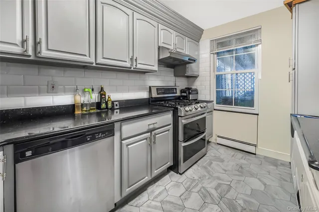 a kitchen with stainless steel appliances granite countertop a stove a sink and a refrigerator