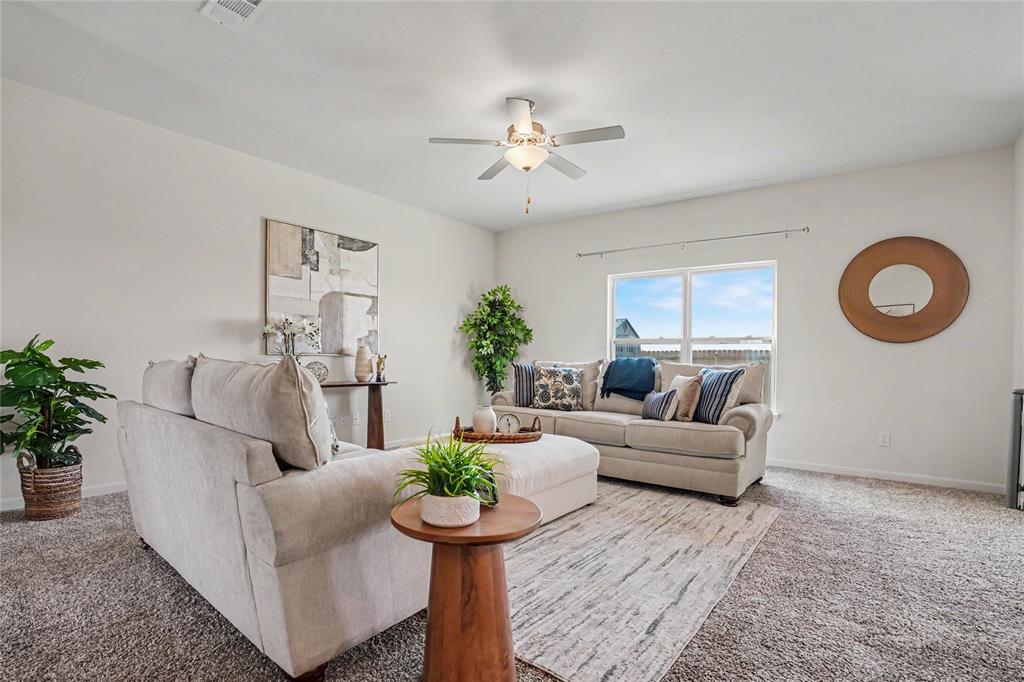 125 Sammy Venus, TX 76084 - Photo 5 of 39 Living area with light neutral wall paint, ceiling fan, carpeting, and a window with a pleasant outdoor expanse