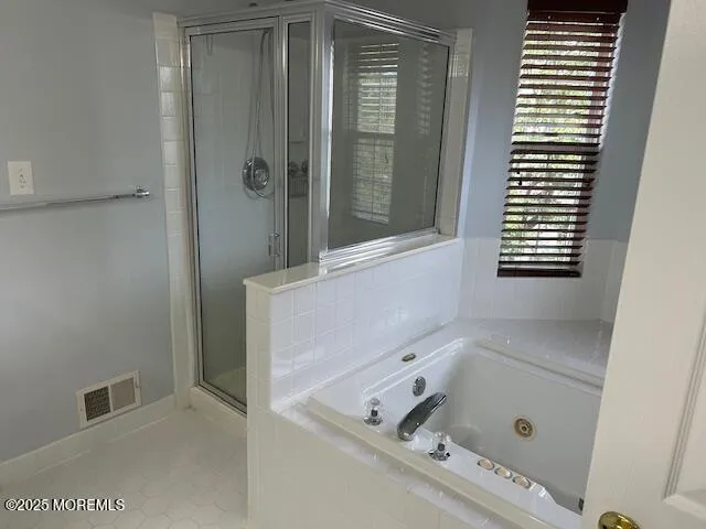 a bathroom with a tub and shower