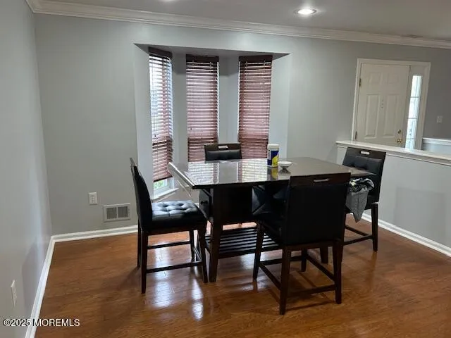 a view of a dining room with furniture and window