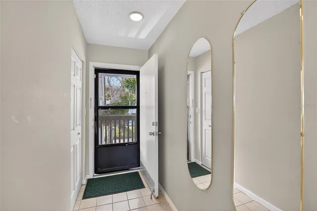 a view of a big room with wooden floor a ceiling fan and windows