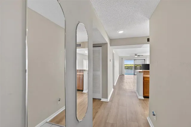 a kitchen with stainless steel appliances granite countertop a refrigerator a stove top oven a sink and dishwasher with wooden floor