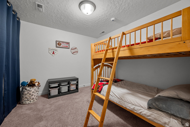 1708 North 1280th Street East Payson, UT 84651 - Photo 8 of 15 Bedroom featuring a built-in wooden bunk bed with ladder, wall-to-wall carpeting, light-toned walls, and a flush-mount ceiling light fixture