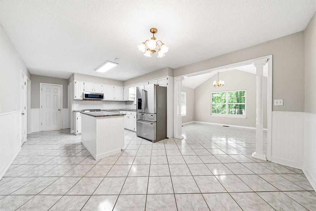 116 Monterey Drive Dalton, GA 30721 - Photo 16 of 39 a large white kitchen with cabinets appliances and a window