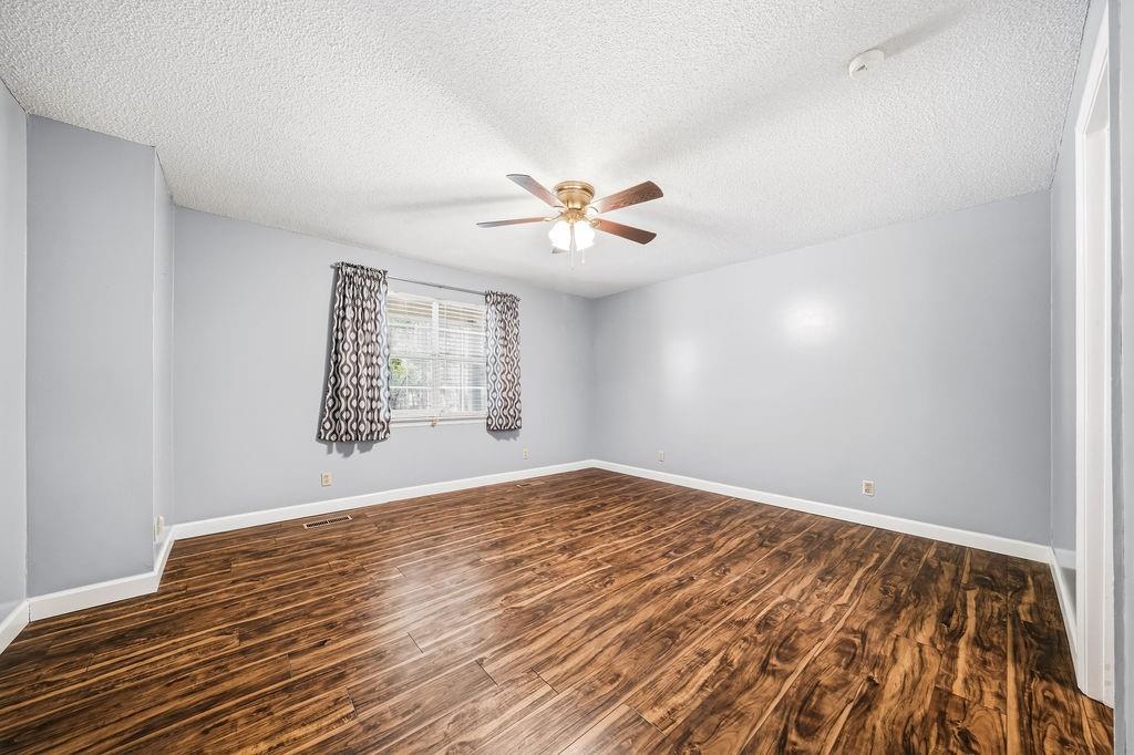 116 Monterey Drive Dalton, GA 30721 - Photo 26 of 39 an empty room with windows and ceiling fan