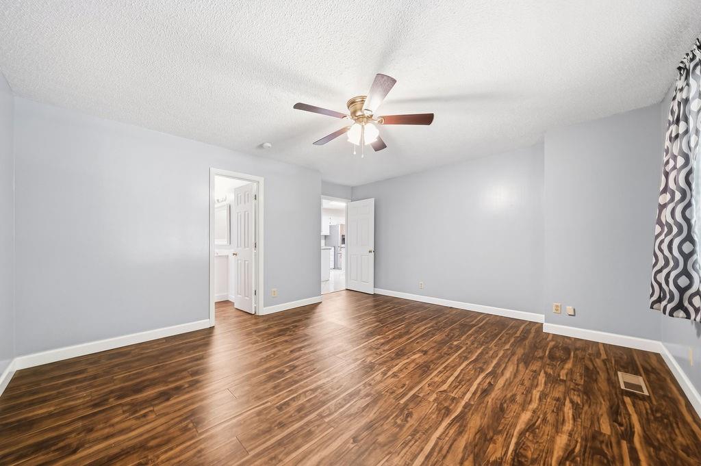 116 Monterey Drive Dalton, GA 30721 - Photo 27 of 39 a view of an empty room with window and wooden floor
