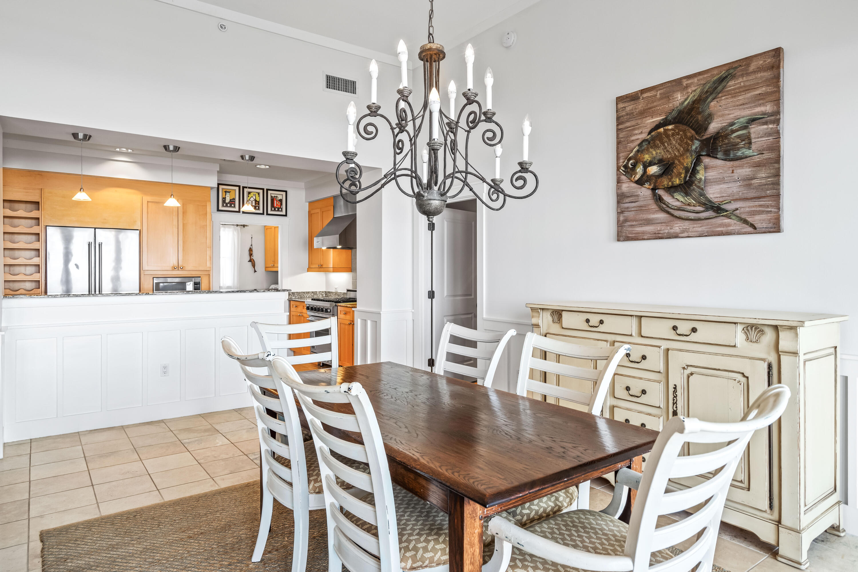337 Bridge Lane, Unit 421B Watersound, FL 32461 - Photo 21 of 55 a view of a dining room with furniture a chandelier and wooden floor