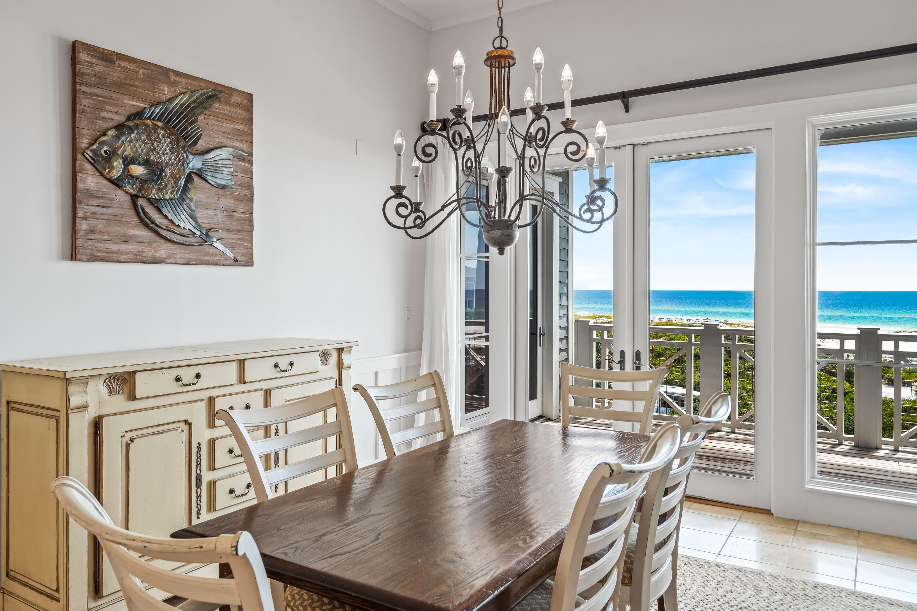 337 Bridge Lane, Unit 421B Watersound, FL 32461 - Photo 24 of 55 a view of a dining room with furniture a chandelier and wooden floor