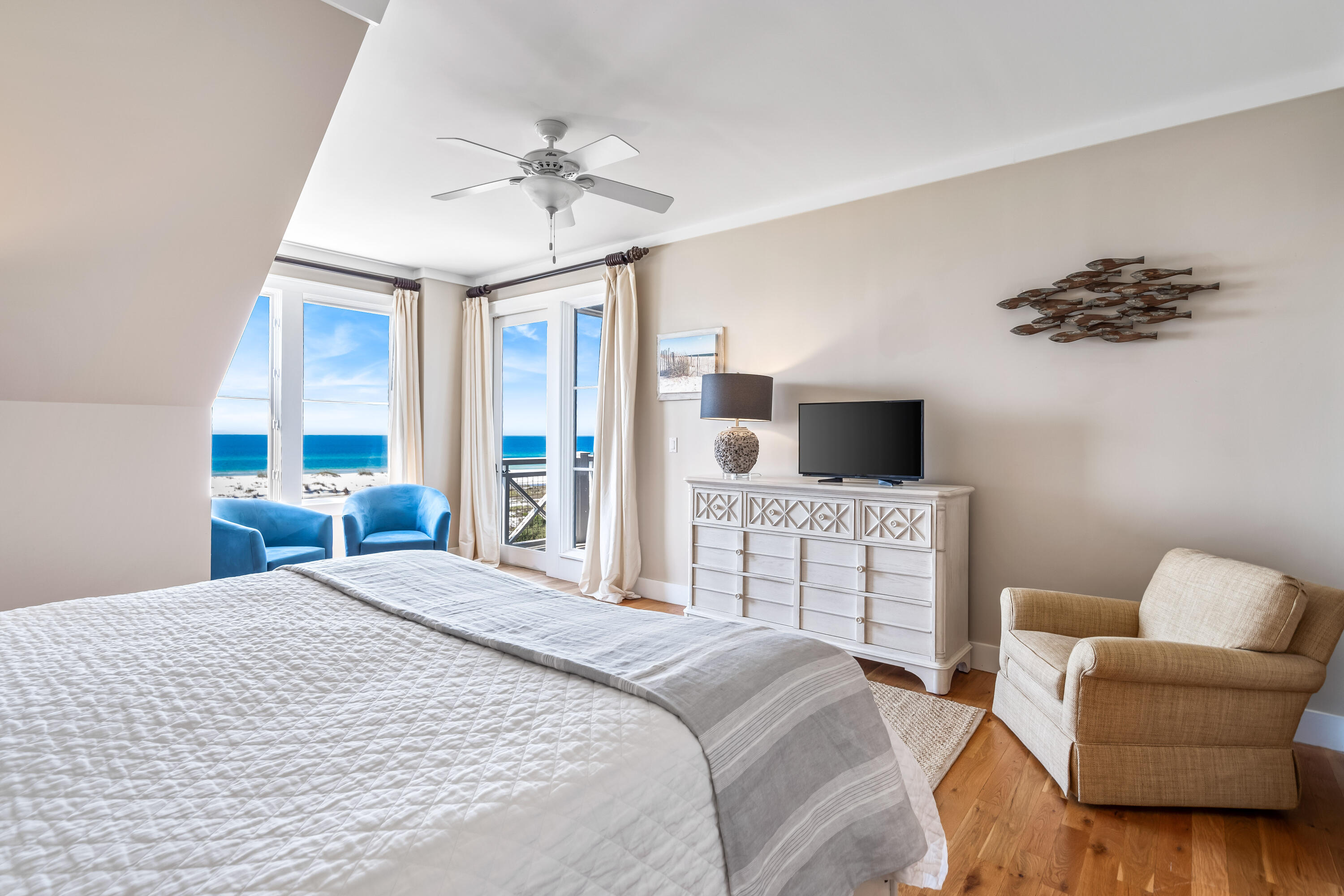 337 Bridge Lane, Unit 421B Watersound, FL 32461 - Photo 27 of 55 a bedroom with a large bed a flat screen tv and a couch