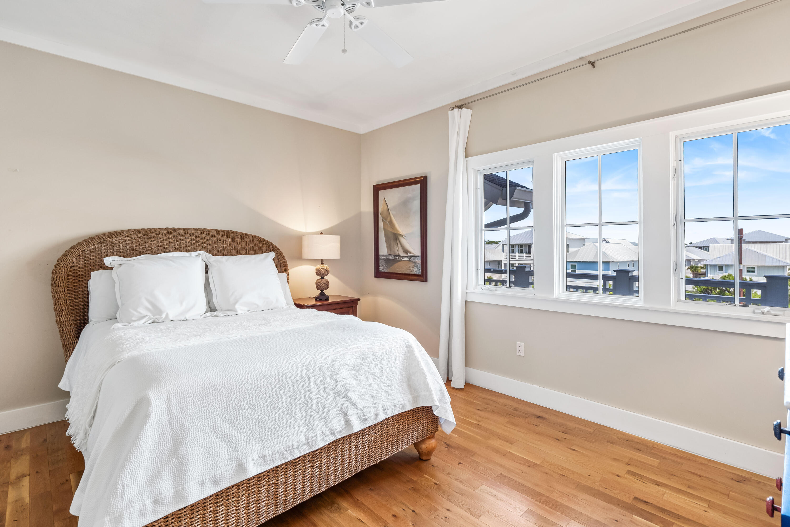 337 Bridge Lane, Unit 421B Watersound, FL 32461 - Photo 30 of 55 a bedroom with a large bed and a large window