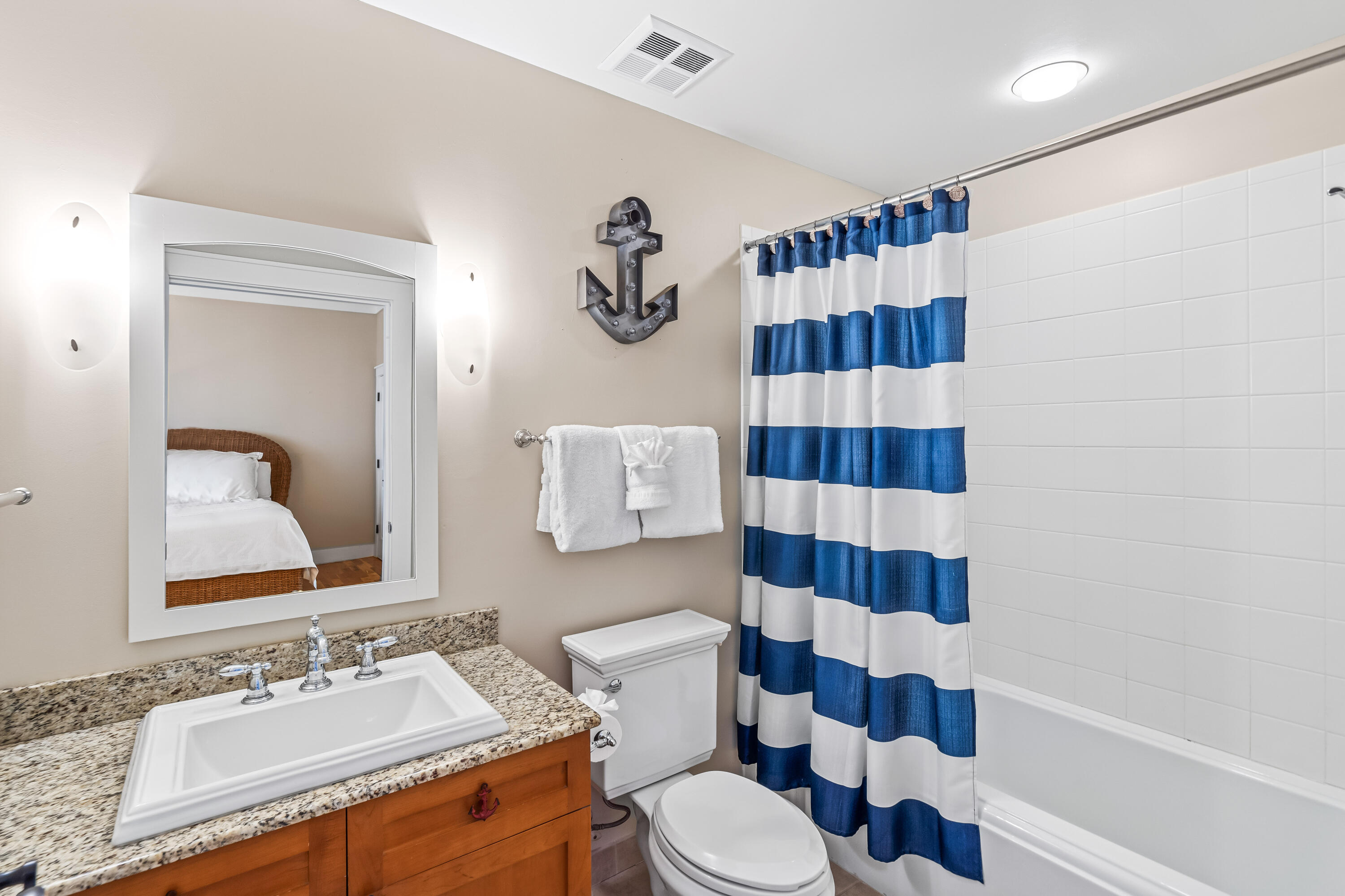 337 Bridge Lane, Unit 421B Watersound, FL 32461 - Photo 33 of 55 a bathroom with a sink a toilet a shower and a mirror