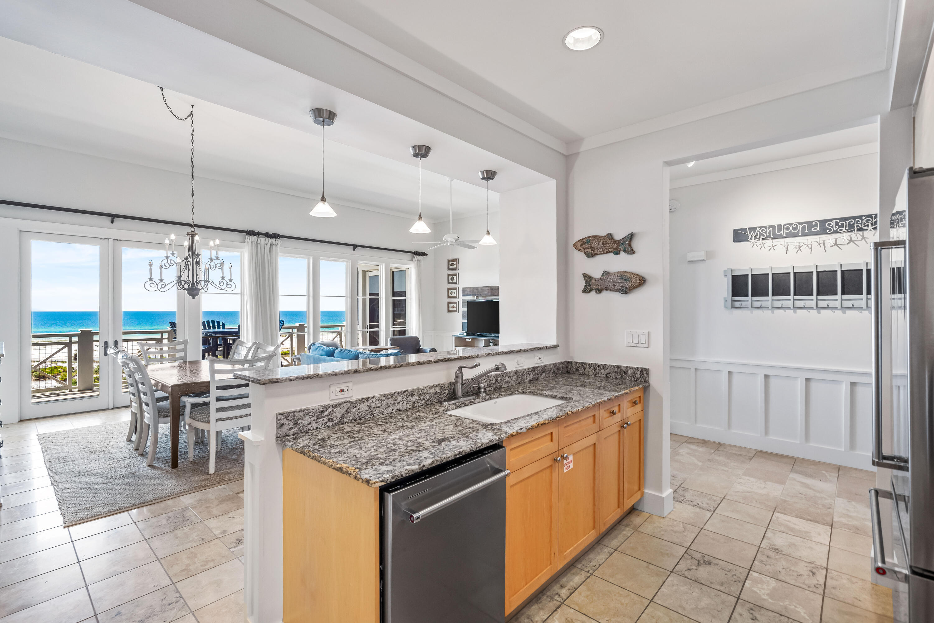 337 Bridge Lane, Unit 421B Watersound, FL 32461 - Photo 34 of 55 a open kitchen with a table and chairs