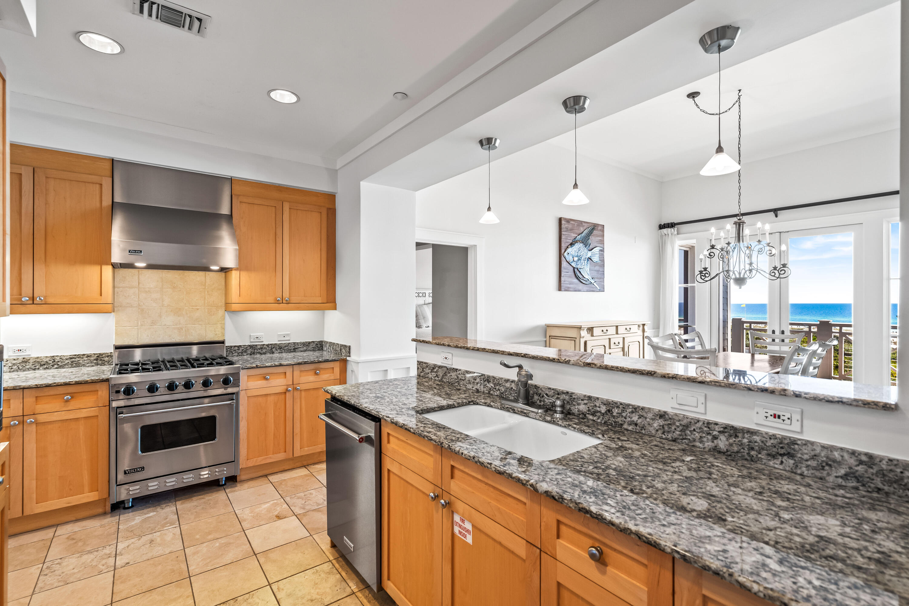 337 Bridge Lane, Unit 421B Watersound, FL 32461 - Photo 35 of 55 a kitchen with stainless steel appliances granite countertop a stove a sink and a refrigerator