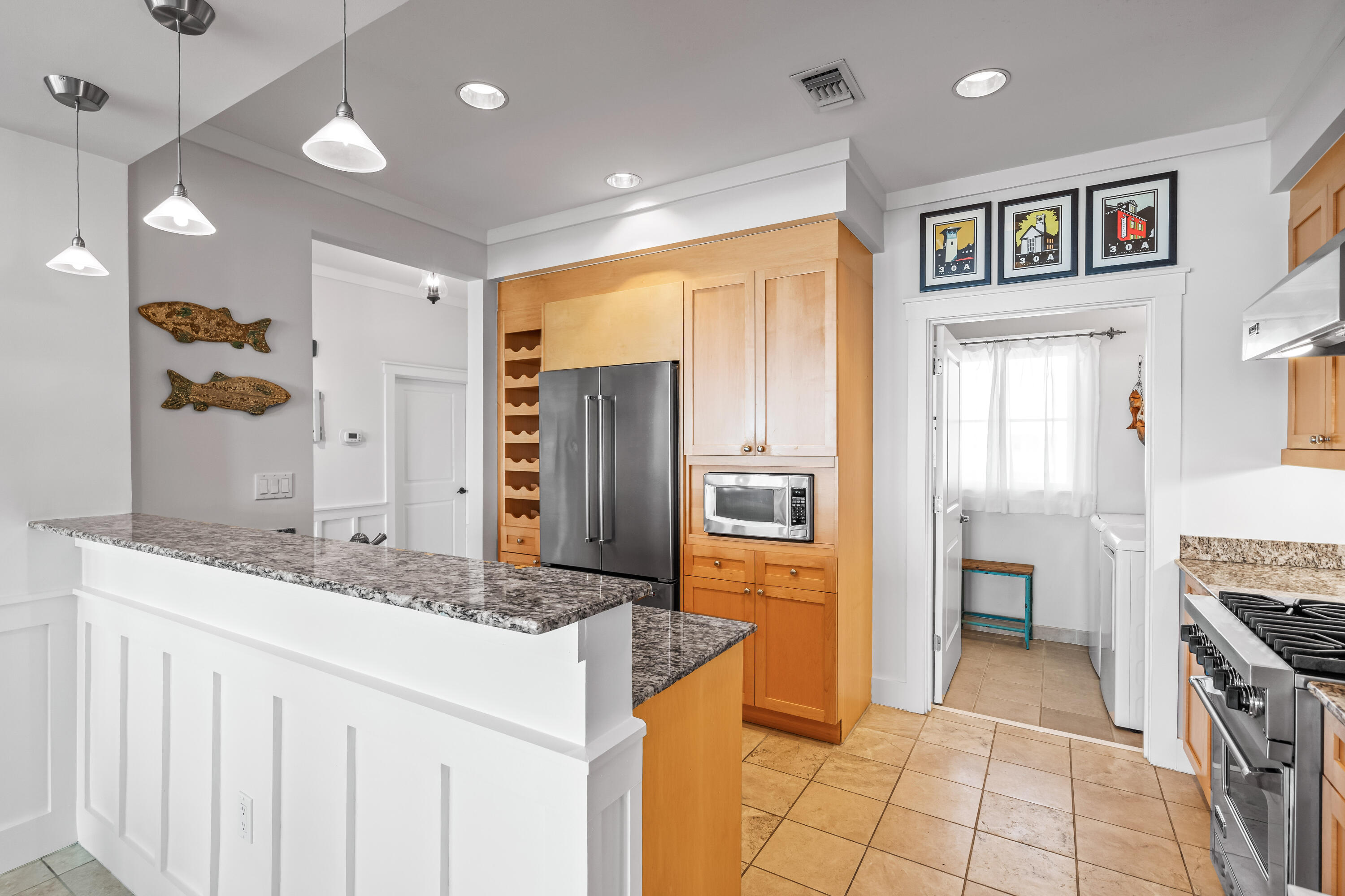 337 Bridge Lane, Unit 421B Watersound, FL 32461 - Photo 36 of 55 a kitchen with granite countertop a refrigerator and a sink