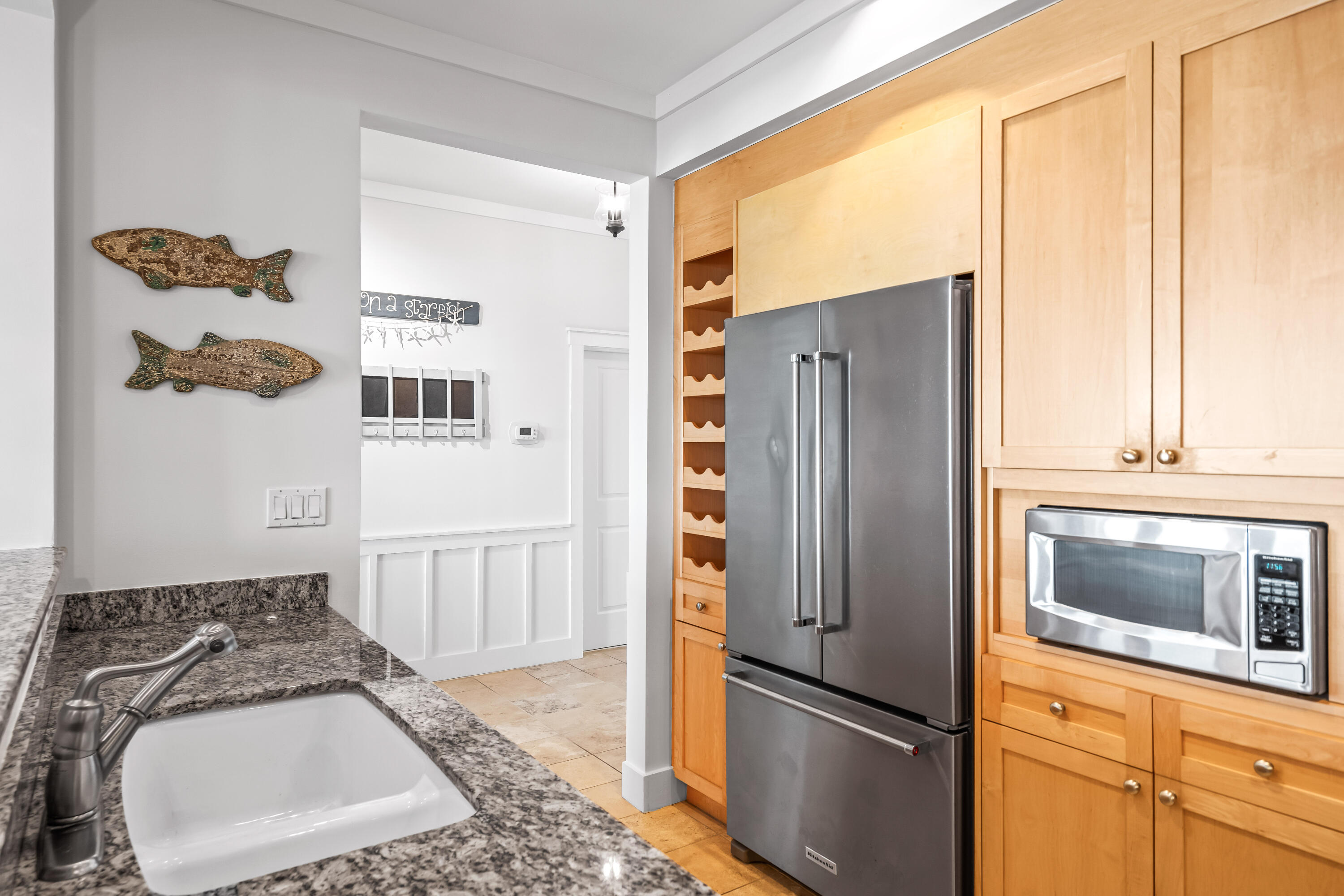 337 Bridge Lane, Unit 421B Watersound, FL 32461 - Photo 37 of 55 a kitchen with granite countertop a refrigerator and a stove top oven