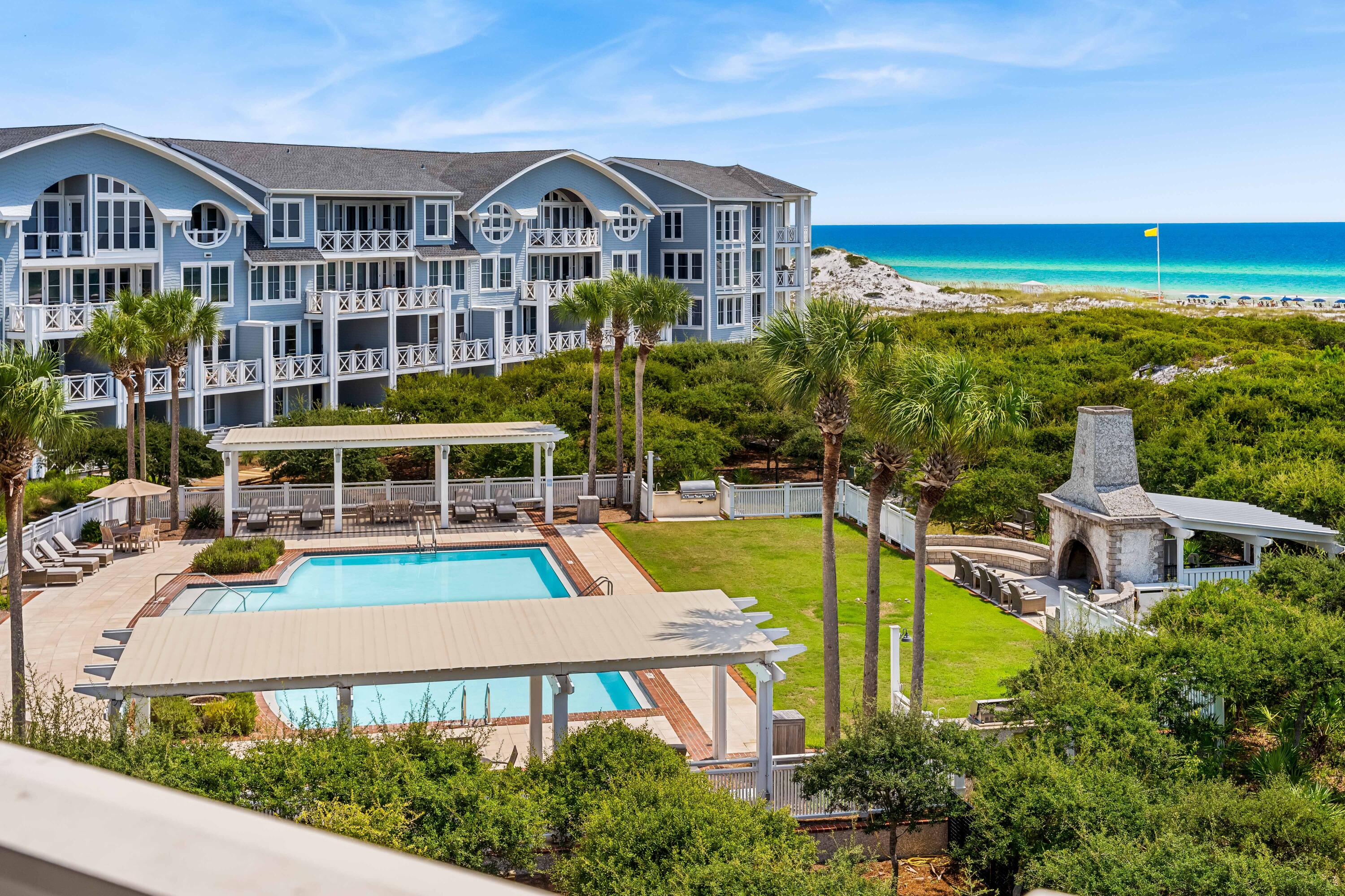 337 Bridge Lane, Unit 421B Watersound, FL 32461 - Photo 42 of 55 a view of a swimming pool with a lounge chairs