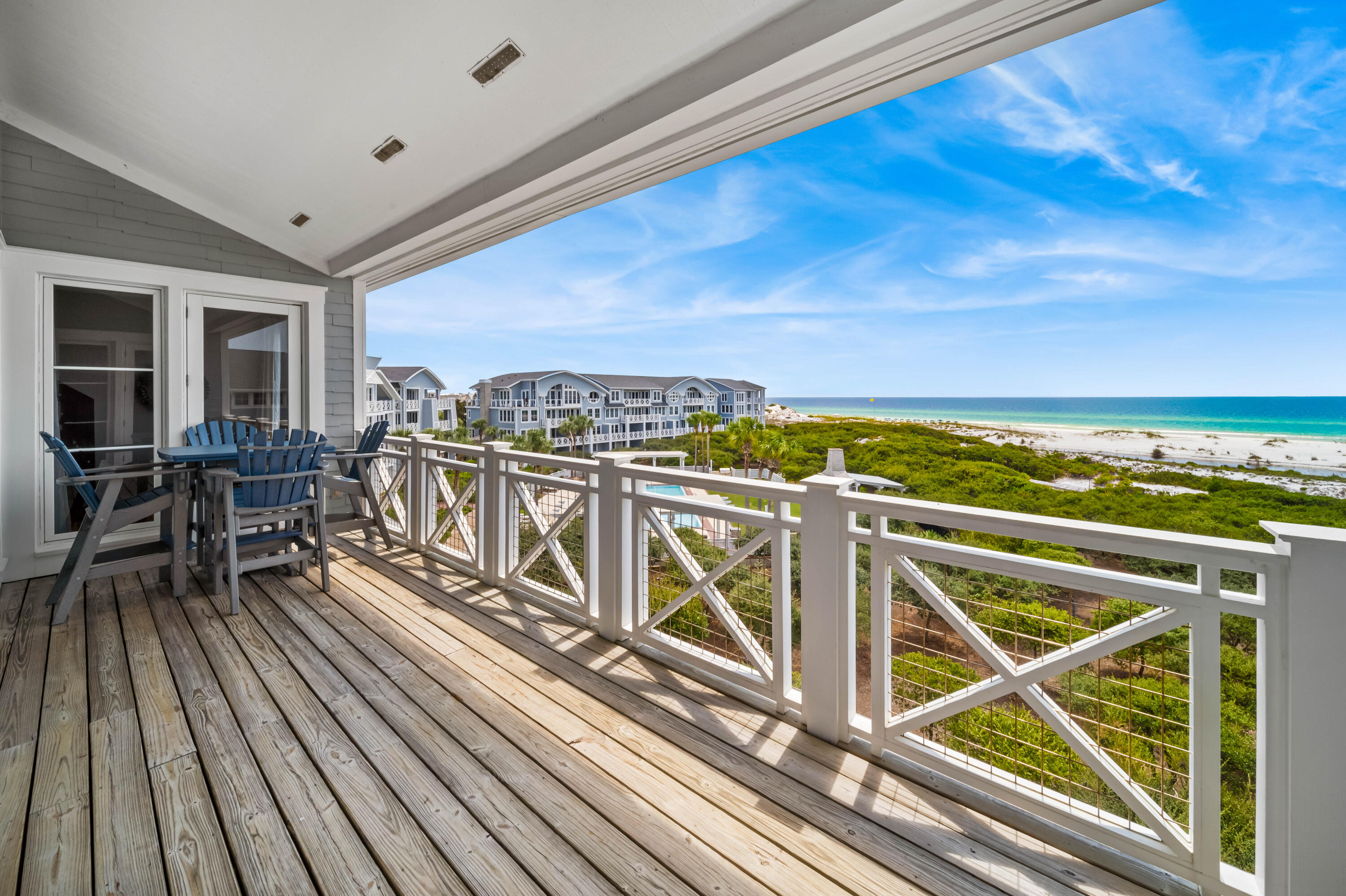 337 Bridge Lane, Unit 421B Watersound, FL 32461 - Photo 45 of 55 a view of a chairs and table on the wooden floor