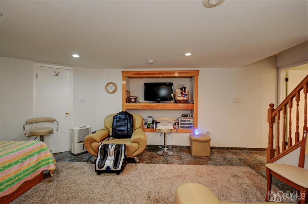 414 Inwood Road Linden, NJ 07036 - Photo 16 of 33 a room with furniture and a flat screen tv