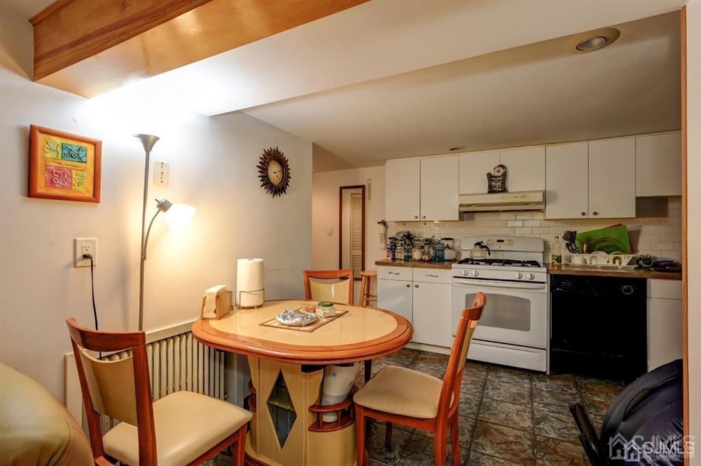 414 Inwood Road Linden, NJ 07036 - Photo 18 of 33 a kitchen with a dining table chairs and refrigerator