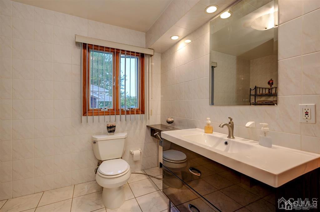 414 Inwood Road Linden, NJ 07036 - Photo 20 of 33 a bathroom with a sink toilet and mirror