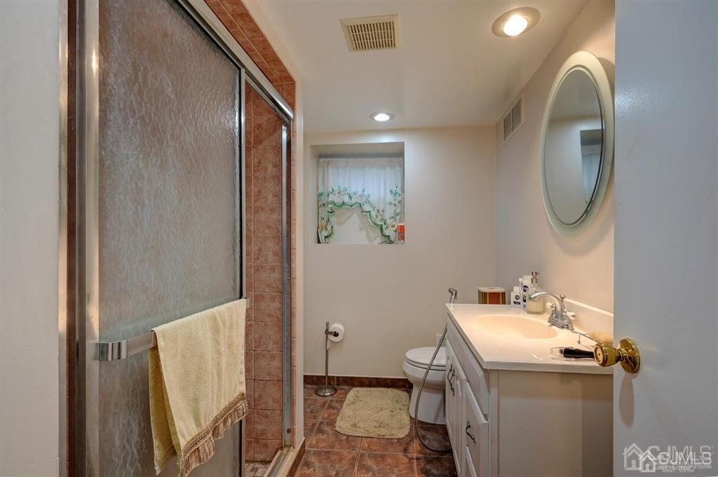 414 Inwood Road Linden, NJ 07036 - Photo 23 of 33 a bathroom with a sink and a mirror