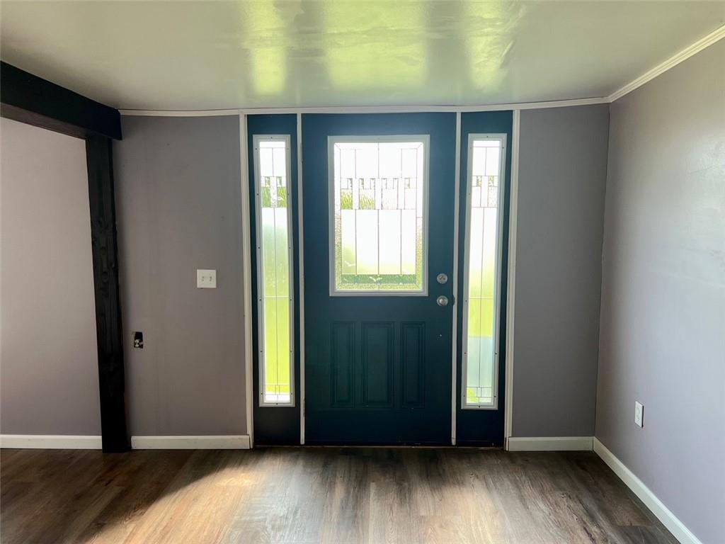 597 Yankee Ridge Road Mercer, PA 16137 - Photo 5 of 23 an empty room with wooden floor and windows