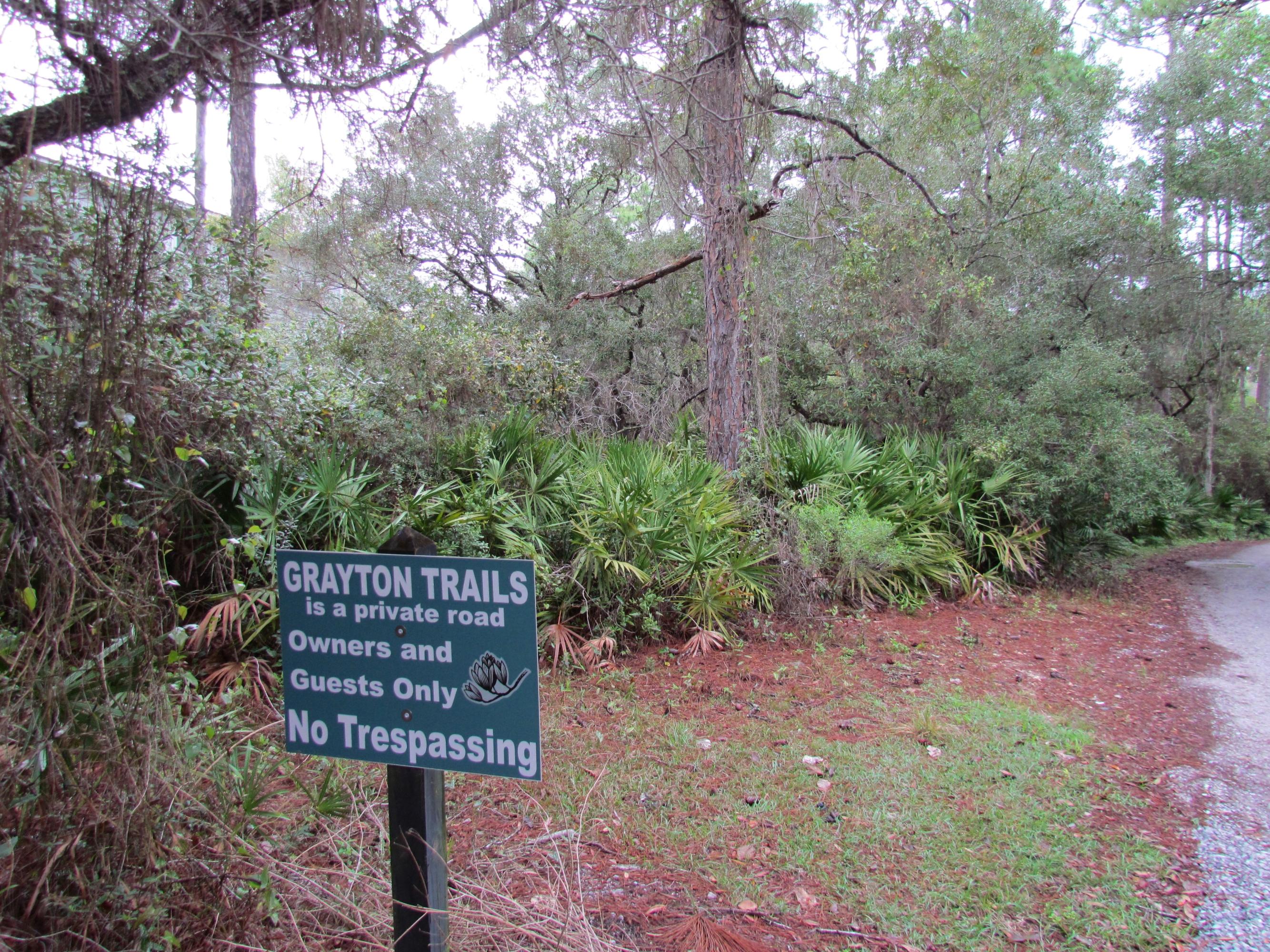 Xxx Grayton Trail Road Santa Rosa Beach, FL 32459 - Photo 1 of 5 a sign board with a bench in the forest